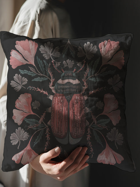 Elegant black pillowcase featuring detailed coral-red beetle illustration centered amid symmetrical pink flowers and gray-green foliage. The dark background enhances the intricate entomology artwork with fine detailing throughout the botanical and insect elements.